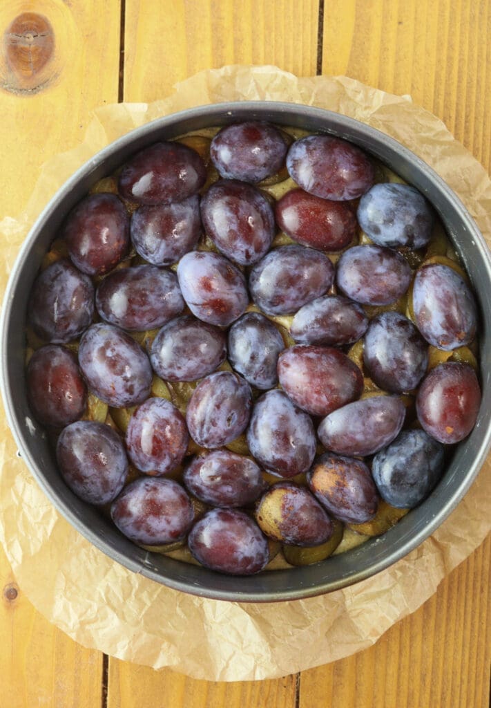A layer of plums facing upside down.